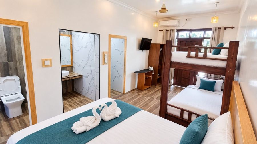 Family room with a double bed, a wooden bunk bed, TV, wardrobe and bathroom